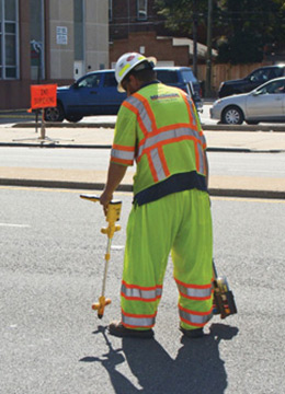 Engineer marking drilling spot for utility locating