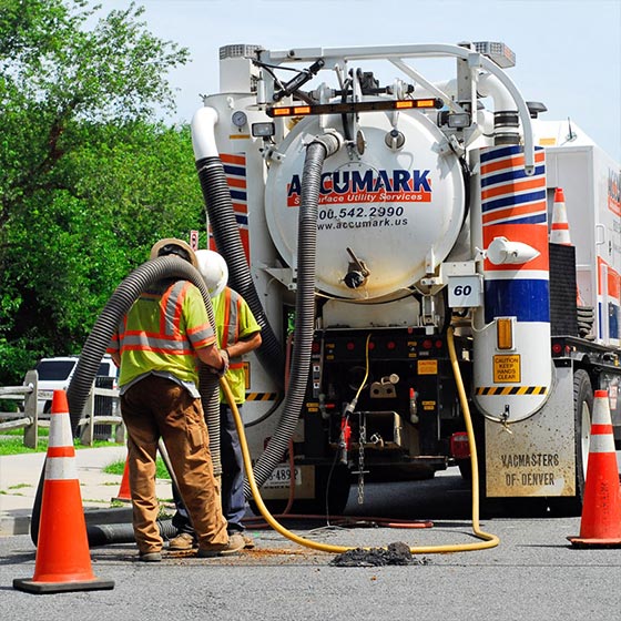 Operators running vacuum pipeline to subsurface utilities