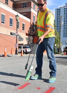 Engineer marking drilling spot for utility locating