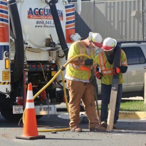 Operators inspecting sewer manhole